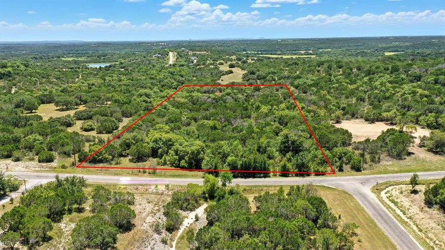 Gorgeous 5-acre lot located in the scenic Mountain Lakes Ranch community of Bluff Dale, TX.  This level, build-ready property features a blend of soft and hardwoods, native grasses, deep seasonal creek, and tree-lined meadow is perfect for a secluded homesite. The land is rich in natural character and attracts local wildlife and is ideal for those seeking outdoor enjoyment, privacy, and stunning hill country views. Fencing is already in place on two sides. Enjoy exceptional community amenities, including an approximately 45-acre fishing lake, aprox 100-acre recreational lake, RV park, clubhouse, community pool, play park, exercise park, and a garden co-op. Conveniently located near Granbury, Stephenville, Weatherford, Glen Rose, and within easy reach of the DFW Metroplex.  Come experience the charm, beauty, and peace of Bluff Dale.