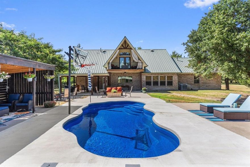 Welcome to your own slice of paradise! This stunning 14+ acre property offers the perfect blend of peaceful country living and modern convenience. Surrounded by nature with unparalleled privacy and space, this property boasts a wooded backyard perfect for wildlife watching, exploring, or simply enjoying the serenity. With over 14 acres, there’s ample room for outdoor recreation, gardening, or future expansion. Step inside to find a bright and open living room with soaring ceilings and an abundance of natural light. The eat-in kitchen is complete with quartz countertops, double ovens, a spacious island, and tons of cabinet space. A built-in desk provides the perfect work nook, while the pretty sunroom offers a peaceful spot to relax with a morning coffee. The primary bedroom suite is a true retreat, featuring a luxurious ensuite bathroom with a soaking tub and an enormous shower with dual rainfall showerheads. A secondary primary bedroom downstairs also includes a private ensuite, ideal for guests or multi-generational living. Upstairs, a dedicated game loft with an office, gaming area, and versatile bonus room provides endless entertainment options for family and friends — plus a balcony overlooking the pool and outdoor living area. Step outside and unwind in your own resort-style oasis. Enjoy the sparkling pool and outdoor kitchen — perfect for hosting gatherings or simply taking in the peaceful country sunsets. Equipped with propane, well water, septic, and three convenient RV hookups, this property offers both comfort and independence. A massive 30x40 insulated shop with electricity, fully wire with 220v circuits and its own bathroom is ideal for hobbies, projects, storage, or even a home-based business. Great location less than a mile from Bowie Airport. Experience the best of both worlds — the privacy and quiet of the countryside combined with the modern amenities and space you’ve been dreaming of.