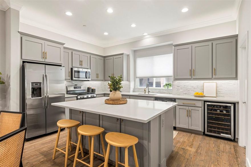 This stylish East Dallas townhome offers an unbeatable floorplan and exceptional indoor-outdoor living—complete with a private rooftop deck showcasing stunning downtown views. Thoughtfully designed across four levels, *the layout features a rare first-floor office and a top-floor second living area*, perfect for entertaining or relaxing.

The main living level is bright and open, with large windows and updated finishes throughout. The kitchen is a true centerpiece, boasting an oversized island with bar seating, a wine fridge, walk-in pantry, and sleek, on-trend design. Hardwood floors, crown molding, custom blinds and generous natural light elevate the space.

Upstairs, both bedrooms are on the third floor, each with spacious en-suite bathrooms. The fourth floor opens to a second living area and direct access to the rooftop—a perfect setup for sunset cocktails or morning coffee with a view.

Additional highlights include a *gated community with ample guest parking*, epoxy-coated 2 car attached garage, and beautiful wood floors throughout the interior. Rarely does a home offer this much style, function, and outdoor appeal in such a prime East Dallas location!