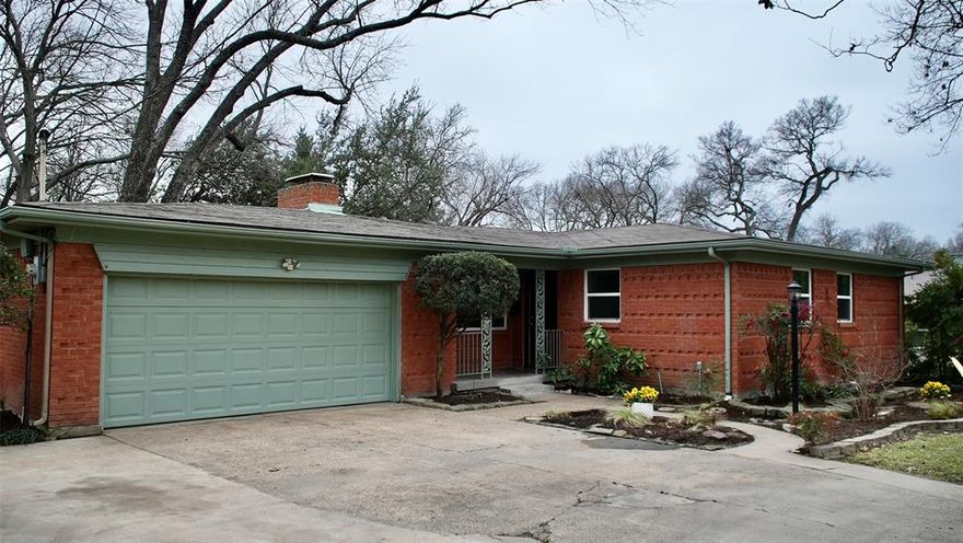 Situated on one of the most unique lots in East Dallas, this beautifully renovated three-bedroom mid-century home sits on over half an acre backing up to Ash Creek. Step into your backyard oasis, where towering trees and the soothing sound of a waterfall cascading over the creek dam make it easy to forget you’re in the city. Inside, the open floor plan features a striking fireplace and expansive windows that flood the home with natural light, reflecting off refinished hardwood floors. The dine-in kitchen has been fully updated with new cabinetry, upgraded appliances, and quartz countertops. The primary suite is a true retreat, offering a luxurious en-suite bathroom with a large walk-in shower and dual-sink vanity. Two additional bedrooms and an upgraded full bath provide flexible living options. Additional improvements include energy-efficient windows throughout, fresh interior paint, and updated light fixtures.