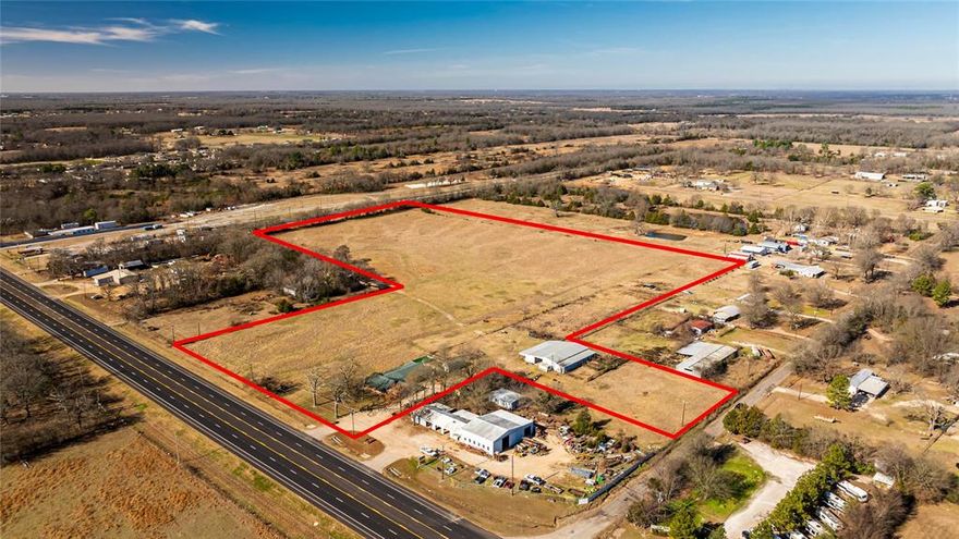 Rare opportunity to own 22.16 acres with NO restrictions. High visibility highway frontage that offers potential for commercial use, single family development, or a long-term investment such as mobile home or rv park. This expansive tract provides easy access, wide-open space, and flexibility for a variety of uses! This property includes a 3 bedroom, 2 bath residence with a 6,000 sqft barn with electricity & water.  The highway exposure makes this property ideal for businesses needing visibility, accessibility, and room to grow! Whether you're an investor looking to secure acreage in a strategic location or a business owner needing space with frontage, this property offers location, land, a homestead, place for your business, and so much versatility! Hard combination to find!