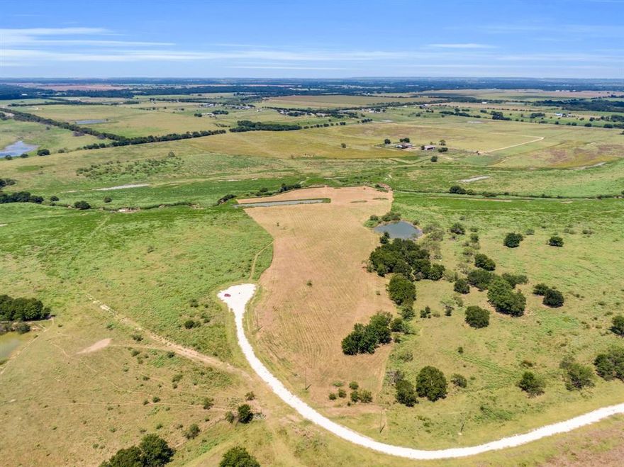 10.2 Acres in the picturesque community of Grand View Ranch! 

Not all acreage is created equal—and this property proves it.

Position your home on the higher elevation and enjoy expansive, UNOBSTRUCTED VIEWS from your back porch—something flat land simply can’t offer. The topography naturally lends itself to a walk-out basement, multi-level design, or a thoughtfully engineered retaining wall, creating a home that feels integrated into the landscape rather than placed on top of it.

Beyond design, the elevation supports improved drainage and usability, helping maintain the integrity of your homesite over time.

Ideally located near the end of a CUL-DE-SAC, the property backs up to a 145-acre ranch on the outskirts of the development, maximizing PRIVACY, PEACEFUL surroundings, and the breathtaking view of OPEN LAND with horses and grazing cattle nearby. A SEASONAL CREEK runs along the rear of the property, adding charm and a natural backdrop.

Whether you’re envisioning a luxury home or a stylish barndominium, you will be in good company—several already dot the landscape of this beautiful ranch community. Deed restrictions help protect your investment by EXCLUDING MOBILE HOMES. Horses are warmly welcomed, and the property is currently AG EXEMPT, keeping your TAXES LOW.

If you’re looking for wide-open spaces, privacy, and peaceful COUNTRY LIVING without being too far from town—this is the land you have been searching for!

** Please reference the survey photo for a clear indication of property lines. The tract was inadvertently mowed in excess of the property boundaries. Specifically, this tract skirts the tip of the pond, it does not include it. Additionally, the property stretches further beyond the stream in the back than what the photos show. 

HORSES, CHICKENS, AND DOMESTIC LIVESTOCK are welcome with the exception of pigs, hogs and peacocks!