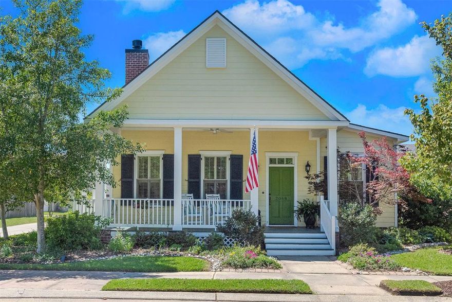 Prime corner-lot home in Provenance overlooking Windrush Park, complete with a welcoming wide front porch perfect for enjoying the neighborhood’s charm. This light-filled 2-bedroom, 2 and a half bath home features warm pine wood floors, plantation shutters, and a welcoming living area with fireplace. Just off the entry, French doors open to a highly desirable flex room—ideal for a home office, guest space, or additional living area. The layout offers a natural flow from the living room into a defined dining area, with the kitchen thoughtfully positioned just beyond—providing connection while maintaining a sense of separation. The kitchen features granite countertops, stainless appliances, island seating, and generous storage. The primary suite includes a large walk-in closet, dual vanities, soaking tub, and separate shower, with laundry conveniently located nearby. A second bedroom and full bath are positioned in a separate area of the home, offering privacy and versatility for a variety of living arrangements. Just inside the rear entry is a convenient half bath and functional mudroom or drop zone. Outside, lovingly curated gardens create a peaceful, private setting, complemented by a covered patio, charming breezeway, and a 2-car garage with attached storage. A working vegetable garden, along with established blueberry and blackberry bushes, is tucked into a sunny back corner of the lot—ideal for enjoying fresh, homegrown harvests. Walk to a bank with post office, dining, and neighborhood events, or enjoy Provenance amenities including parks, pool, clubhouse, and gym.