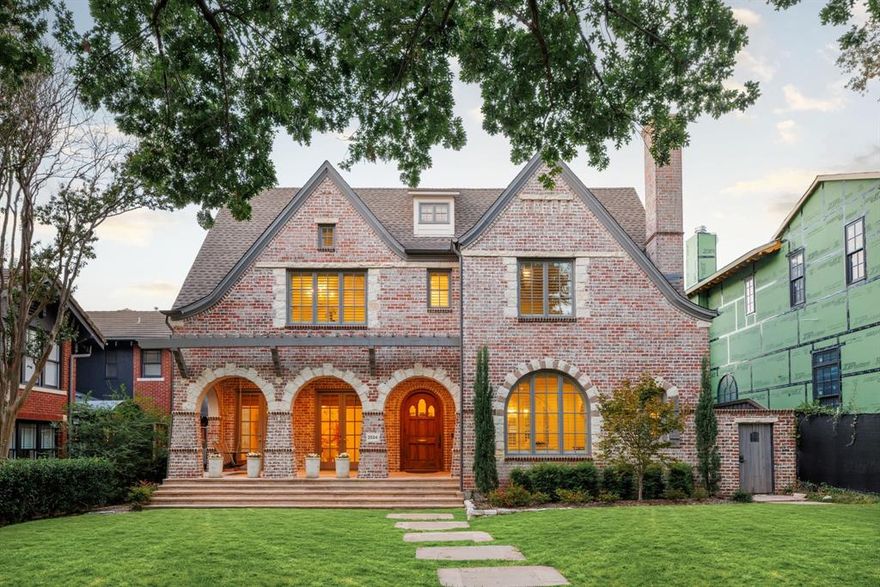 Recently reimagined with timeless elegance & refined design, this stunning Highland Park Gage home is a true masterpiece. Thoughtfully updated within the past year, it showcases exceptional craftsmanship, sophisticated finishes, and meticulous attention to every detail. Perfectly positioned on a picturesque 60x150 lot just one block from Armstrong Elementary, this 5 bed, 6.1 bath residence effortlessly blends classic architecture with modern luxury. From the moment you arrive, the home’s signature façade—with its inviting covered porch, charming arbor, and graceful stone accents—sets the tone for the beauty within. Step inside to a warm and welcoming entry, where chevron-patterned hardwood floors lead the way. The elegant dining room, crowned with a cove ceiling and framed by French doors, opens to lush outdoor views, creating a seamless indoor-outdoor experience. The heart of the home is the expansive family room, anchored by a striking fireplace and flowing effortlessly into the light-filled breakfast area and chef’s kitchen. Designed for entertaining, the kitchen boasts premium stainless-steel appliances and a butler’s pantry with a wet bar. A powder bath and a versatile downstairs bedroom with Murphy Bed and ensuite bath—also ideal as a pool bath—complete the main level. Upstairs, the luxurious primary suite feels like a private sanctuary, featuring dual spa-inspired bathrooms and custom his-and-hers closets. The second level also includes a spacious family game room, two generous bedrooms with ensuite baths, and a beautifully expanded utility room and flex space—each thoughtfully curated by Nickey Oates. On the third level, a fifth bedroom and full bath offer privacy and comfort for guests or extended family. Every space in this exceptional home has been designed to inspire—combining timeless architecture, graceful flow, and modern comfort to create an atmosphere of understated elegance and everyday ease.