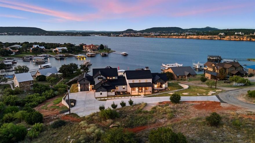 Iconic NEW BUILD Lakefront Retreat in Gaines Bend!!
Situated in a calm cove of the highly sought-after Gaines Bend community, this iconic home offers the perfect blend of privacy and lakefront living. With immediate access to the main channel of Possum Kingdom Lake, you’ll enjoy seamless days on the water from your private dock with 12ft of water and oversized boat garage. The spacious open-concept design includes 5 bedrooms, each with its own private en suite, creating a comfortable retreat for family and guests. A home office, second living space, wine room, dry bar, butlers pantry and more are just a few extras in this custom new build home! Designed for entertaining, the home offers a pool and hot overlooking PK, a fully equipped outdoor living center, and expansive spaces that flow effortlessly from indoors to out. Whether relaxing by the water, hosting friends around the pool, or setting off for a day on the lake, this property captures the best of Possum Kingdom living.
