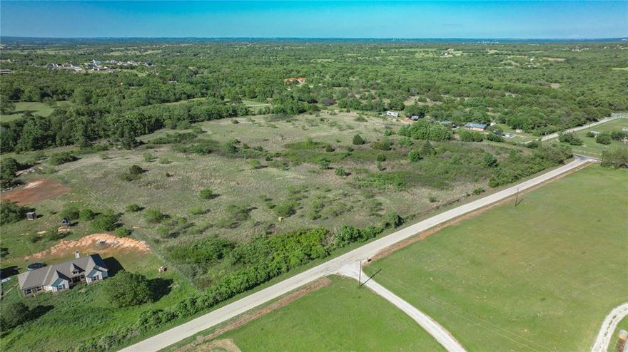 Discover the perfect blend of country living and convenience with this 5-acre tract of undeveloped land in Boyd, located within the highly regarded Springtown ISD. Surrounded by mature trees and offering breathtaking sunset views, this property provides a serene setting with light restrictions that allow you to create the lifestyle you’ve envisioned. Just 30 minutes from the DFW metroplex, it’s close enough for easy commuting while still offering the peace and privacy of rural living. With water and electricity available at the road, this land is ready for your dream home, ranch, or investment project.