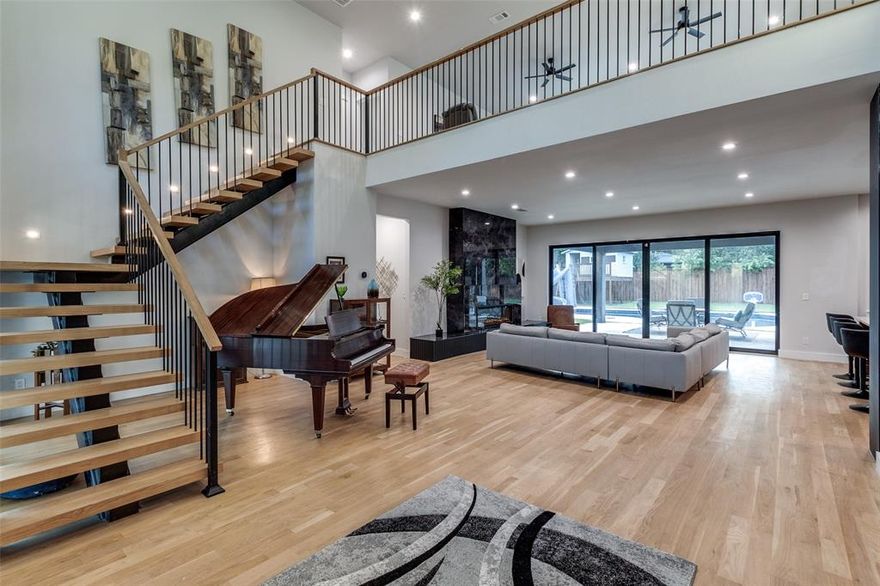 Welcome to your beautifully remodeled mid-century modern home in coveted Northwood Hills. This two-story stunner is an entertainer's dream set on a generous .57 acre lot. This contemporary architectural gem was taken to the studs in 2023 with all new electrical wiring, plumbing, HVAC, two tankless water heaters, new roof, white oak floors and vanities, and 10 foot and 9 foot ceilings on the first and second floors, respectively. Upon entering, your eyes are drawn to the backyard oasis seen through large sliding glass doors off the main living area. The sleek kitchen includes elegant quartzite countertops, Wolf appliances, and built-in Sub-Zero refrigerator, Cove dishwasher, crushed icemaker, beverage fridge and second filtered sink. Start your morning with a coffee from your plumbed-in Miele coffee maker which sits stylishly above the built-in microwave. The ample pantry includes a second dishwasher and sink and a Sub-Zero built-in wine fridge, and is ideally located behind the kitchen, next to the garage. The living and kitchen areas feature views of the spectacular yard, including an inviting quartz pool. The pool and equipment were updated in 2023-2024. Entertain easily on the 2 patios and watch the kids enjoy the large waterslide and custom-built treehouse. The outdoor bathroom is perfect to accommodate your pool parties. The secluded first-floor primary boasts a luxurious en-suite bathroom and large walk-in closet with its own laundry. Enjoy the evening relaxing on a nearby private patio. Two of the four bedrooms upstairs have en-suite bathrooms; all bedrooms have walk-in closets. Don't miss the additional closet in the front bedroom, perfect for extra storage. The main laundry room is on the second floor. With its bold architectural design and unbeatable location in RISD, this home offers the best of modern luxury living in one of Dallas' most sought-after neighborhoods.