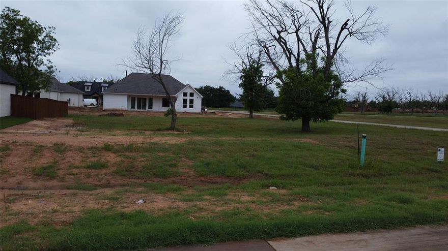 Rare opportunity to own a beautiful .292-acre corner lot in the prestigious, gated community of Pecan Plantation. This level homesite is the perfect canvas for your custom build, offering the added space and privacy that only a corner position can provide. Enjoy an unmatched resort lifestyle with access to two 18-hole golf courses, a full-service clubhouse, tennis and pickleball courts, and a private marina on Lake Granbury.
The monthly HOA fee provides an incredible value, covering 24-7 gated security, common area maintenance, and convenient trash pick-up. With no immediate timeline to build, you can secure your piece of Texas paradise now and design your retreat at your own pace. Residents also enjoy the Village shopping center, featuring a grocery store, pharmacy, and bistro—all accessible by golf cart or a short walk.