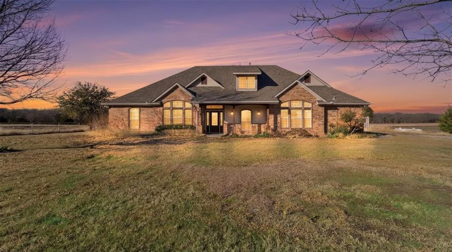 This stunning custom-built home sits on 6 acres, offering privacy, space, and incredible versatility. Designed with both comfort and function in mind, the home features a 2-car attached garage along with a detached 2-car garage and oversized workshop—ideal for storage, hobbies, or equipment.
Inside, the kitchen serves as the heart of the home, showcasing beautiful wood cabinetry and ample workspace. It opens seamlessly to the inviting living room, where a cozy fireplace creates the perfect gathering space for everyday living or entertaining. A bright home office and a separate formal dining room add flexibility for work and hosting.
The well-planned layout is filled with natural light, abundant storage, and peaceful views of the fenced pasture, ready for horses or cattle. The main-level primary suite offers a private sitting area and a large walk-in closet. Two additional downstairs bedrooms share a thoughtfully designed Jack-and-Jill bathroom, each with its own sink for added privacy and convenience.
Upstairs, a spacious second primary suite—or oversized game room—includes a private bath, making it perfect for guests or multi-generational living. Completing the home are an oversized utility room with sink and extra storage, no HOA, a private pond, and an Ag exemption on 5 acres.
Bring your horses, cattle, RV, boat, or hobbies and enjoy the freedom of peaceful country living—this private retreat is ready to welcome you home.