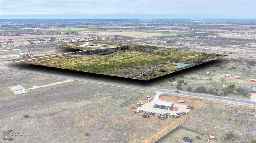 Unique opportunity along State Highway 36 offering flexibility for both residential and commercial use on nearly 35 acres in the Abilene area. The main home, built in 2019, features 3 bedrooms and 3.5 bathrooms with open living areas, a large kitchen, and covered porches overlooking the rolling land. The property also includes an impressive detached structure known as the “Man Mansion,” featuring 6 potential rooms including a loft, a glass-enclosed flex space, a full kitchen, and 2 full bathrooms- ideal for company lodging, executive retreat, or flexible workspace. Located within Abilene’s growing corridor near major employers and incoming developments, this property offers excellent potential for corporate housing, contractor accommodations, training space, or a private residence with income possibilities. The acreage allows for equipment storage, RV hookups, livestock pens, and recreational use, creating endless options for work or leisure. Convenient access to Highway 36 provides both visibility and privacy, making it suitable for a business headquarters, investment property, or live-work setup. Whether used for commercial operations, residential living, or a mix of both, this property combines modern comfort with exceptional versatility in a high-growth area of Taylor County.