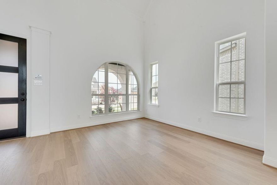 Just completed and move-in ready, this stunning new Grand Home is nestled in a vibrant, master-planned community designed for outdoor living. With striking stone accents, onyx shingles, and a sleek contemporary front door, the curb appeal is undeniable. Located just four blocks from resort-style amenities including a pool, playground, fishing pond, and scenic bike trails, this home offers both luxury and lifestyle. This north facing home sits on a lot that faces a peaceful pond and is backed to a greenbelt with walking trail.
Inside, the design boasts four spacious bedrooms, including a private guest suite on the main floor—ideal for visitors, a nursery, or a home office. The dramatic vaulted family room features rich wood floors, a gas fireplace, and is pre-wired for a flat-screen TV, creating a perfect space to relax or entertain. Formal living and dining areas add elegance and versatility, while upstairs, a large game room and dedicated media room provide fun and comfort for the whole family.
Custom design touches include a sleek staircase with wrought iron spindles, 8-foot interior doors, and Rev Wood flooring. The open concept kitchen is a chef’s dream, with granite slab countertops, Shaker-style cabinetry, a gas cooktop with a sleek stainless and glass vent hood, full bowl sink, trash can drawer, spice cabinet, and an oversized island at the center of it all.
Retreat to the luxurious primary bath featuring a garden tub, Marlana vanities with rectangular sinks, and a glass-tiled walk-in shower. Bedroom four even includes its own private reading loft, adding charm and functionality. This home is also equipped with modern conveniences like a security system, sprinkler system, and energy-efficient construction with R-38 insulation, 2x6 walls, and full Energy Star certification.
With full builder warranties and designer upgrades throughout, this is more than a new house—it’s your new home.