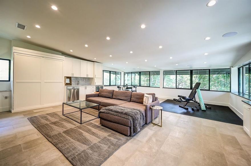 An exquisite multi-level condo that seamlessly blends modern comfort with smart home features in a prime central Dallas location. This meticulously updated residence offers a thoughtful layout with standout amenities throughout. The top floor features a stunning 700-square-foot living area complete with a wet bar and secondary kitchen, perfect for entertaining or transforming into a media room, home office, or gym—all while enjoying serene treetop views and complete privacy. The main kitchen is a true showpiece, boasting luxurious marble countertops and backsplash, a large island, stainless steel appliances, and a bright breakfast area that enhances the space. The primary living areas and kitchen are outfitted with automatic blackout shades, offering privacy and convenience at the touch of a button. Additional highlights include recessed lighting, rich wood and heated flooring, expansive windows, two coffee bars, and thoughtful design elements across multiple levels. Step outside to your private balcony or relax in the fenced garden—ideal for pets or enjoying the outdoors. This home also features a private garage, carport, shed, and both indoor and outdoor staircases. Both the garage and carport include EV charging capabilities, making it a perfect choice for eco-conscious homeowners. With easy access to major freeways, entertainment, dining, and shopping, this condo offers a rare combination of modern style, smart technology, and unbeatable location.