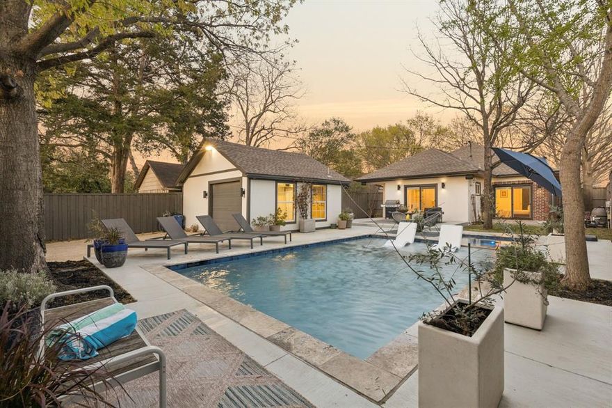 A thoughtfully curated 1920s craftsman bungalow offering designer level updates and a private resort style backyard, ideally located minutes from the historic charm of Winnetka Heights Historic District and the vibrant dining, shopping, and culture of Bishop Arts District.
Blending timeless architecture with modern comfort, this home has been renovated with careful attention to detail. The light-filled interior features custom paint, refinished walnut accents, updated flooring, custom windows, and integrated Sonance in-ceiling speakers that enhance the main living spaces while preserving the home’s original character.
The kitchen has been beautifully refreshed with refinished cabinetry, a new backsplash, updated tile flooring, and a custom window above the sink that fills the space with natural light. A refinished walnut bar adds warmth and functionality, creating an inviting setting for both everyday living and entertaining. 
The primary suite has been completely reimagined to create a true retreat, featuring a custom double vanity with quartz countertops, elegant tilework, new custom windows, and a thoughtfully designed closet with built-in storage and drawers. Additional improvements throughout the home include updated HVAC, interior and exterior custom paint, and numerous upgrades that provide both comfort and efficiency.
Step outside to discover what truly sets this property apart. The backyard has been transformed into a private oasis featuring a heated in-ground pool and spa, outdoor JBL speakers, and a dedicated pool bath, an exceptional amenity rarely found in homes of this era. A custom sliding gate with LiftMaster operator provides added privacy and convenience, while recent landscaping and exterior improvements complete the space.
With extensive renovations, distinctive outdoor living, and a location near some of Oak Cliff’s most beloved neighborhoods, this home offers a rare combination of historic charm, modern design, and resort style living.