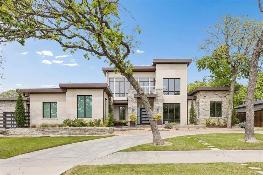 Welcome to your modern sanctuary of serenity and sophistication. One of a kind custom built modern home, nestled nearly on half an acre, designed to impress from the very first glance. Striking drive up appeal & clean architectural lines, this home makes a bold statement while offering exceptional functionality and luxury throughout. Step into a grand foyer with soaring 25 ft ceilings, frameless glass office & a wall of windows centered around a private courtyard with a resort style sparkling pool, this design creates seamless indoor-outdoor living. The heart of the home is the commercial grade chef's kitchen featuring high-end SS appliances, sleek finishes and an oversized waterfall island that serves both as a statement and for entertaining. Premium embellishments include side by side SS 64in refrigerator, Wolf 8 gas burner range, Miele vent a hood, insta hot faucet, 2 dishwashers, wine frig, & ice maker. Relax in the living room while enjoying the calming build-in fireplace & views of the pool. Primary bedroom has 2 generous walk-in closets plus built-in dressers, shoe racks including one built as a bunker style with passcode capabilities. Ensuite bath has enormous shower, dual shower heads plus a rain shower feature, jetted soaking tub, double vanities and separate built-in vanity for your get ready moments. Other highlights include private loft style glass gym equipped with rubber flooring, perfect for your weight workout or pilates, offset from 2 patios. Additional features, a putting green, outdoor firepit, ample yard and deck, plus pool is equipped with high velocity swimming jets & optional heating functions + spa. Mudroom & walk-in laundry room w storage, dual countertops, pet washing station. 5 car garage has epoxy flooring with built-in workstation. This home is a perfect blend of architectural sophistication, luxury amenities, and everyday comfort crafted for those who appreciated design, privacy and elevated living! Coppell Farmers Market a short walk.