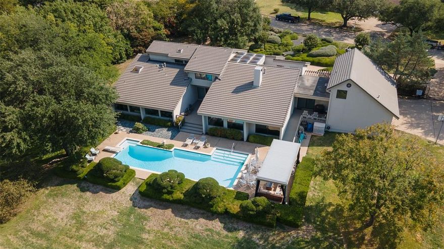 Rare opportunity to own over 2 acres on the Ridglea Country Club north golf course on the 11th fairway.  The meticulously maintained home features 5 bedrooms, 5.1 baths, 3 living areas, formal dining area plus several bonus areas and 3 car garage.  Stunning atrium showcased by 4 walls of glass on interior of home.  Vaulted ceilings and massive windows that showcase the pristine landscaping and sparkling pool with covered pergola.  See through gas fireplace between living room and music room.  Master has office area or sitting area.  Abundant storage throughout including staircase to floored attic storage.  Pool resurfaced approximately 3 years ago.  Iron fencing and automatic gate to garage.  Concrete tile class 4 roof.  Abundant storage throughout including staircase to floored attic storage.