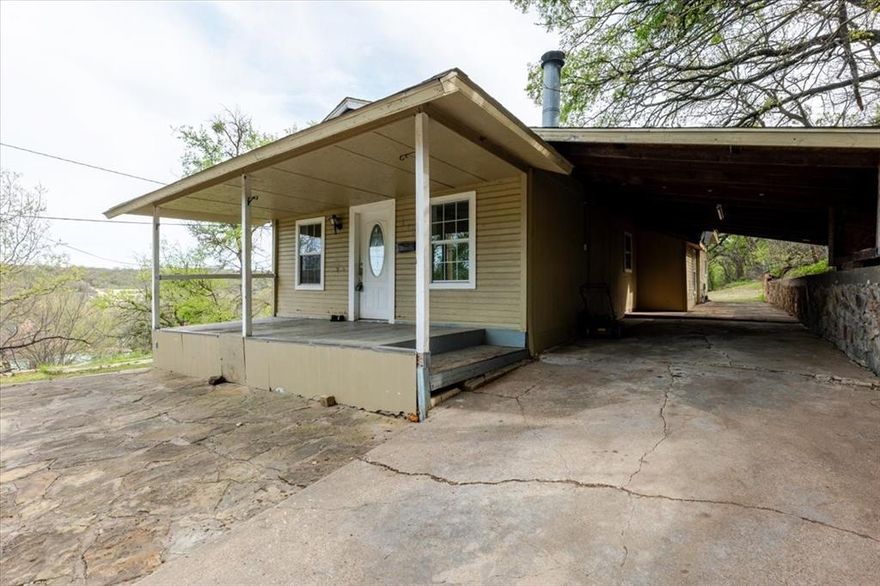 Views, Views, VIEWS! From the back patio lies the grand Baker Hotel and historic downtown Mineral Wells! This 3 bed 2 bath home is a rarity with no neighboring homes immediately next to it. As you enter home, a rock wood burning fireplace greats you on the right. As you walk through living room, you will enter the kitchen with gas range and entry beyond into the dining area. All of the bedrooms are in the middle and rear of the home. Large designated utility room. Primary bedroom with ensuite bath is in the back left-hand side of the home near the back door. Other highlights to this home are the large covered front deck and attached single carport. The PERFECT starter home! Submit all offers on finaloffer.com
