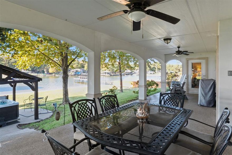 **Lakeside Retreat with Dual Masters** Discover the dream of lake life at this exceptional waterfront home on Cedar Creek Lake in Gun Barrel City.  Thoughtfully designed, this residence stands out with two primary bedrooms and two and half baths, offering an ideal setup for guests, multi-generational living or a perfect roommate scenario.  You will adore the interior floor plan with a built in desk area, fire lit living room and a spacious kitchen and breakfast bar!   The exterior is built for enjoyment. Spend your spare time on the spacious back porch staring at the water. A meticulously maintained lawn frames the lakeside view, leading to your very own private boat dock! House your prized boat in the 8000 lb worthy cradle and keep it clean and safe inside the touch-less automatic boat cover.  Imagine mornings on the water and evenings spent relaxing on the back patio or sinking to the warmth of the outdoor spa hot tub!  Convenience is key with a two-car garage and a prime location that puts you just minutes from popular dining and retail options.  This isn't just a home: it's a lifestyle upgrade. ** Seller is open to providing concessions for interest rate buy-down or any other modifications suitable for buyer**