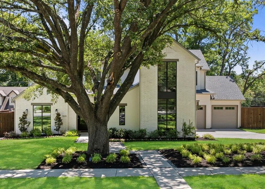 Perfectly situated on a generous 0.37-acre lot near White Rock Lake and zoned to Lakewood Elementary, this custom home blends privacy, elegance, and intentional design. From a rare 4-car garage to a sparkling pool, expansive yard, and refined finishes, this residence is a true standout. Inside, natural light fills the open-concept layout, where designer touches elevate every room. The family room features exposed beams and a striking fireplace, seamlessly flowing into a showstopping kitchen with a waterfall island, white oak accents, custom cabinetry, Viking appliances, and a hidden working pantry. A stylish wet bar with wine storage enhances the home’s entertaining appeal. The first-floor primary suite is a serene retreat with views of the backyard and a spa-like bath featuring a freestanding tub and massive walk-in closet. A spacious study with a full bath and closet offers flexibility  as a currently configured 7th bedroom. Upstairs, enjoy a central game room with four oversized secondary bedrooms—each with an en-suite bath and walk-in closet. One has been transformed into a fully equipped home gym. Expansive sliding doors open to an outdoor paradise: pool, spa, kitchen, fireplace, and ample lawn space designed for gathering and play. Just minutes from White Rock Lake and the Santa Fe Trail, this home offers a rare combination of luxury and lifestyle in the heart of Lakewood.