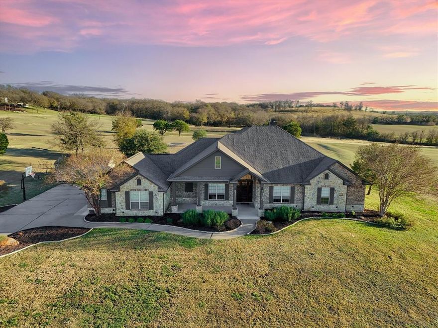 Absolutely stunning custom home on 2.016 acres in highly sought-after Lorena, Texas! This impressive 3,694 sq ft residence offers 4 spacious bedrooms, including two primary suites, along with a dedicated office showcasing gorgeous scenic views. Step inside to an open-concept floor plan designed for both everyday living and entertaining, where the chef’s kitchen truly serves as the heart of the home. Enjoy gorgeous quartz countertops, a prep sink, dreamy 5 burner gas range, and large walk-in pantry, all overlooking the expansive family room with a cozy wood-burning fireplace. The main primary retreat features two walk-in closets, a serene spa-like bath with freestanding soaking tub, walk-in shower, and dual vanities, plus direct access to the laundry room through the closet. A second bedroom suite boasts its own full bath. Upstairs, you’ll find an oversized bonus room currently used as a home theater. Outdoor living is just as impressive with an enclosed back patio featuring a second kitchen, grill, and half bath, ideal for entertaining year round. The pool-ready backyard already includes electric provisions for pool equipment and a convenient outdoor shower, along with an in-ground trampoline, fire pit, and separate storage building. The oversized three-car garage offers workbenches, sink, and dedicated freezer & refrigerator space. Additional features include spray foam insulation for energy efficiency and high-quality finishes throughout. This one truly has it all—space, luxury, functionality, and location. Call to schedule your showing today!