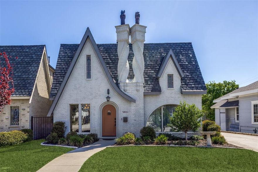 Life truly meets art in this iconic downtown McKinney home, instantly recognizable for its striking dual twisted chimneys crowned with whimsical chess-piece caps. Architectural details such as arched doors and windows, stained-glass accents, and handcrafted finishes give this home a vintage, storybook quality—while modern updates ensure comfort and convenience.
One of only 10 original Tudor-style homes built by Rockbrook Developers, this thoughtfully designed 3-bedroom residence offers multiple spacious living areas and a layout ideal for both everyday living and entertaining. The main level features genuine hardwood floors, a marble floor in the half bath, a private office (or optional bedroom), and a beautifully appointed kitchen complete with a gourmet gas range, butler’s pantry, and center island. Upstairs, you’ll find all bedrooms along with a convenient laundry area. A charming stained-glass nook offers flexible space for a study, playroom, or workout area. The expansive primary suite includes dual sinks, a soaking tub, and a separate shower. A mini-split AC system upstairs provides enhanced comfort and energy efficiency. Step outside to a covered back patio and enjoy the added functionality of a detached garage with an opener and built-in shelving. Seller is willing to leave fridge, washer, and dryer currently in the home with an acceptable offer. Stained glass panels in front rooms and the primary bedroom can stay. Professionally landscaped and full of character, this home is perfectly positioned just three blocks from Historic Downtown McKinney Square. No need to fight for a parking place to enjoy dining, shopping, and beloved downtown festivals like Home for the Holidays McKinney and McKinney Oktoberfest, and so many more. This is more than a home—it’s a lifestyle in one of McKinney’s most treasured neighborhoods.