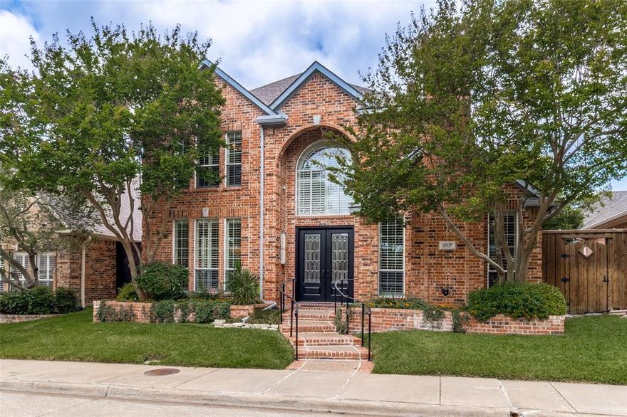 An exceptional blend of style, space, and function defines this Royal Lane Village home, ideally situated in a highly sought-after zero lot line community where homes are rarely available.
This two-story residence offers a thoughtfully designed layout with generous living spaces, architectural detail, and a seamless flow balancing quiet living with lively gatherings. Vaulted ceilings, abundant natural light, and a blend of wood, tile, and marble flooring create an interior that feels both refined and comfortable.
The main level features multiple living areas, including a spacious living room and den—each with its own fireplace—along with a formal dining room and a dedicated office that could serve as a fourth bedroom. The centrally located kitchen is well-equipped with a large island and pantry, opening effortlessly to the surrounding spaces for easy connection.
The first-floor primary suite provides a private retreat, complete with a garden tub, separate shower, dual vanities, and a walk-in closet. Upstairs, a large game room and secondary bedrooms with Jack and Jill bath offer flexibility for a variety of living arrangements. The floor plan provides both openness and defined separation where needed.
Outdoor living includes a private, landscaped backyard and a patio shaded by an arbor with a ceiling fan—an inviting setting for relaxing or entertaining. A rear-entry garage with additional storage and HOA-maintained front yard add to the home’s overall convenience.