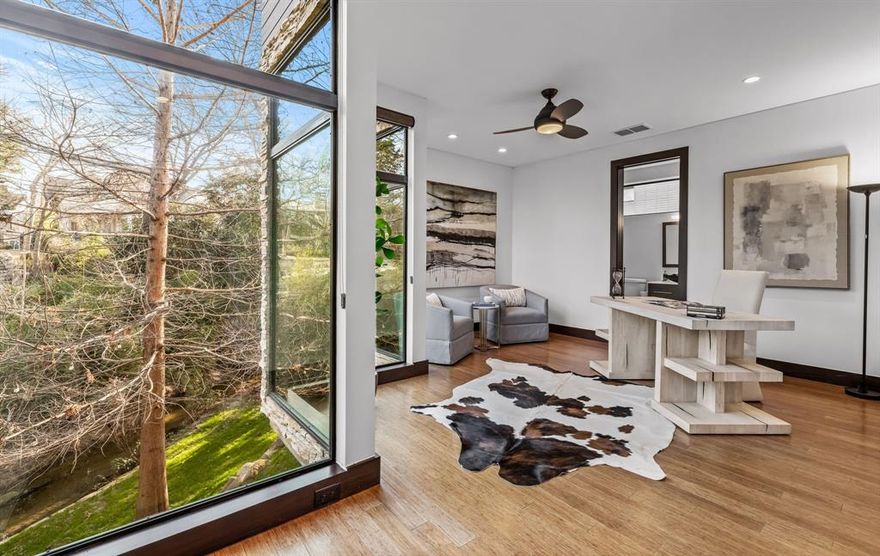 Nestled amidst nature, a truly unique residence offers a tranquil escape from the hustle and bustle of city life. Situated on a spacious double lot along The Beards Branch of White Rock Creek, this home boasts stunning panoramic views of lush greenery and a peaceful creek from every room, seamlessly blending the indoors with the outdoors. The carefully designed outdoor area provides endless entertainment possibilities year-round, featuring a luxurious pool, a cozy fire pit creekside, and sounds of a natural waterfall. Whether you're lounging in the serene surroundings of the landscaped gardens or exploring the meticulously crafted interiors, you'll experience a harmonious blend of comfort and sophistication. Every aspect of this property has been carefully considered to ensure a harmonious balance of comfort, aesthetics, and functionality, creating an idyllic sanctuary for those seeking a retreat in nature. Lakewood proper, just 1 block from Lakewood Elementary