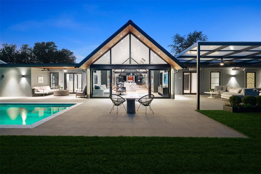 A study in contemporary sophistication, this Los Angeles–inspired residence has been reimagined with uncompromising craftsmanship and a refined indoor–outdoor cadence. A gallery-style entry opens to an airy great room where wide-plank white oak floors, soaring ceilings, and expansive windows bathe the interior in natural light. Anchoring the home is a sculptural, waterfall-edge marble island in the entertainer’s kitchen which is appointed with a full Thermador suite including a gas cooktop and double ovens, paired with dual sinks and dual dishwashers for effortless hosting. Custom cabinetry by Florense, Brazil’s renowned atelier, delivers a sleek, tailored finish. Each bath is individually curated, wrapped in floor-to-ceiling, designer-selected tile for a distinctly bespoke feel. The serene primary suite features dual closets impeccably outfitted with Florense built-ins, offering both beauty and utility in equal measure. Beyond the 3 sets of large glass sliding doors, two covered patios and full outdoor kitchen set the stage for intimate gatherings, while a sparkling pool completes the private, resort-caliber oasis. Impeccable materials, balanced proportions, and luminous spaces make this home as livable as it is luxurious.