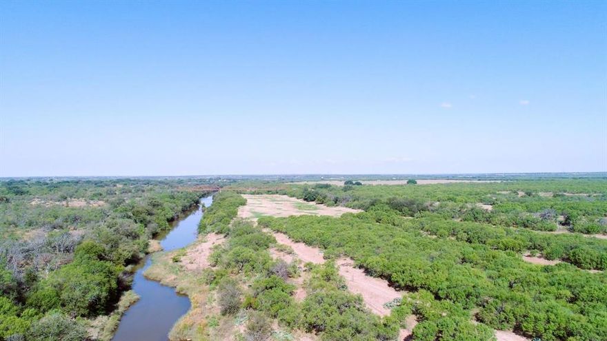A unique opportunity to own a true live water property in West Central Texas.  Access to both sides of Bull Creek which gracefully meanders 1.5 miles through the property, starting at the north end, and runs into the Colorado River.  The south boundary encompasses 0.8 of a mile of Colorado River frontage just East of Waldrip Bridge.  Abundant wildlife including whitetail, Axis deer, & turkey have enjoyed a seven-year respite of hunting.  Fishing is truly exceptional.  Many Arrowheads have been discovered on the property over time & are carefully displayed in the hunter’s cabin, which boasts a full restroom, bunk-style sleeping, hot water & a remotely controlled air conditioning heat system.  40-acre feet of irrigation rights are a rare added value to this property.