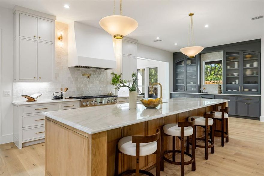 Stunning new construction completed in October by Shoreline Property Group, ideally located in the coveted private school corridor. This 5 bedroom home offers timeless style with rich paneling and soft light filled finishes throughout. Two bedrooms are located on the first floor and three on the second, each floor also has its own powder bath and living area. The formal dining room overlooks the sparkling pool, while the gourmet kitchen features white oak cabinets, quartzite countertops, a built in bar and scullery. A dedicated office, spacious bedrooms and flowing indoor-outdoor living make it ideal for family and entertaining. Outside, enjoy a covered patio with built in barbecue, pool, and plenty of yard space for kids and pets to play. Conveniently located near St. Rita and Jesuit.