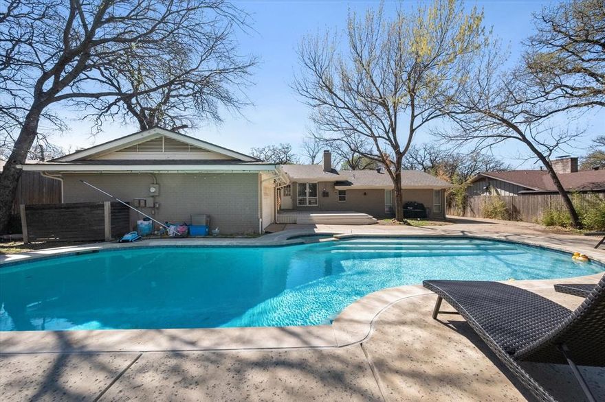 Welcome home! This beautifully maintained one-level brick home is a rare find, perfectly positioned in a central location with effortless access to shopping, dining, and everyday conveniences. Nestled among mature trees, the setting feels private and serene while still being close to it all. Inside, you’ll be welcomed by rich architectural character, including exposed wood beams, custom built-ins, and a cozy wood-burning fireplace that anchors the inviting living space. Large windows flood the home with natural light and create a seamless connection to the backyard oasis, offering views of the sparkling pool. The eat-in kitchen is both stylish and functional, featuring granite countertops, abundant cabinetry, and stainless steel appliances—ideal for casual meals or hosting guests. The spacious primary suite is a true retreat, complete with dual sinks and a large separate shower. Step outside and enjoy your private backyard escape, highlighted by a gorgeous pool that’s perfect for entertaining, relaxing, or soaking up sunny days. The new deck was just installed and stained in 2026. New roof in 2024, new HVAC in 2023. With comfort, character, and convenience all wrapped into one exceptional home, this is a must-see. Schedule your showing today and experience it for yourself!