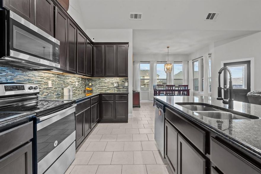 This stunning 4-bedroom, 3.5-bathroom home offers comfort, style, and space to spare. Step into a bright, open-concept floor plan perfect for entertaining, with large windows that fill the space with natural light. The primary suite is a retreat of its own—featuring a spacious ensuite bathroom, an oversized walk-in closet, and direct access to the laundry room for everyday convenience. A second ensuite bedroom downstairs is ideal for guests or multigenerational living, plus a separate half bath for visitors. Upstairs, you'll find two more bedrooms connected by a Jack and Jill bath and a versatile bonus room—perfect for a playroom, home office, or media space. Enjoy the large backyard for barbecues, games, or simply relaxing under the stars. With no HOA and just minutes from variety of schools, shopping, dining, and a quick drive to downtown, this home truly has it all.