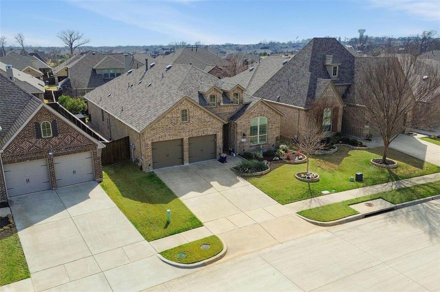 Stunning and spacious 3-bedroom home in a prime Trinity Falls location! Thoughtfully upgraded with plantation shutters throughout, solid wood doors, and enhanced exterior accent lighting that elevates the home’s curb appeal. The light-filled kitchen is the heart of the home, featuring soaring ceilings, white cabinetry, a huge island with breakfast bar, gas cooktop, and a built-in coffee or wine bar with extra storage. The flexible floorplan offers both a private office and a bonus game or media room—perfect for working from home, entertaining, or play. The oversized primary suite—expanded as a builder upgrade—is a peaceful retreat with a wall of windows, a spacious walk-in closet, and a tranquil ensuite bath complete with dual vanities, a garden tub, and a double walk-in shower. The split layout provides added privacy, with secondary bedrooms located separately with a shared full bathroom. All bedrooms feature walk-in closets for excellent storage. Step outside to enjoy a gorgeous covered patio and fully turfed backyard with custom lighting—ideal for relaxing evenings and low-maintenance outdoor living. Located directly across from a large green space and within walking distance to the neighborhood elementary school and incredible community amenities including pools, parks, pickleball courts, clubhouse, fitness center, dog park, ponds, trails, and disc golf. Conveniently close to major highways, HEB, and vibrant Downtown McKinney. Move-in ready and beautifully maintained!