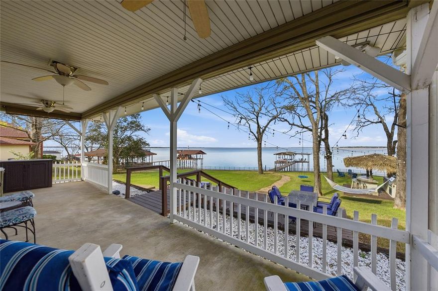 SELLERS ARE MOTIVATED.  Your new waterfront retreat awaits! Recently appraised at $850,000 and priced $75,000 below appraisal, this FULLY FURNISHED lakefront home includes over $95,000 in recent upgrades and NO HOA fees. Enjoy 115 feet of rare, unobstructed lake frontage with a boat dock, motorized slip, and breathtaking sunset views from the dock, backyard, or living room. Situated on a spacious 0.29-acre lot with room for a guest house or outdoor entertainment space, this 4-bedroom, 2.5-bath lake home offers true year-round vacation living with stunning north and northwest-facing water views and calm waters ideal for dock preservation. Two kayaks are included for immediate enjoyment. The backyard is a shaded oasis with mature trees, a large wooden deck, shaded concrete patio, fire pit, and a fully equipped Tiki bar featuring new thatch, gas grill, fridge, fan, LED lighting, and wooden barstools. Meticulously furnished throughout—including all bedrooms, bathrooms, living areas, and kitchen—this home is truly move-in ready. Currently used as a family vacation home, it also offers excellent potential as a future Airbnb or VRBO investment. Included are lake accessories and additional furnishings, adding value beyond the appraisal. Recent upgrades include a brand new roof, a brand new HVAC system, a new electrical panel, fresh paint, new carpet, optimized HVAC ducts, attic insulation, Wi-Fi–enabled water heater and thermostats, RO drinking water system, and dock enhancements. Enjoy walking-distance access to a pavilion, fishing pier, and Harbor Point community events held throughout the year.