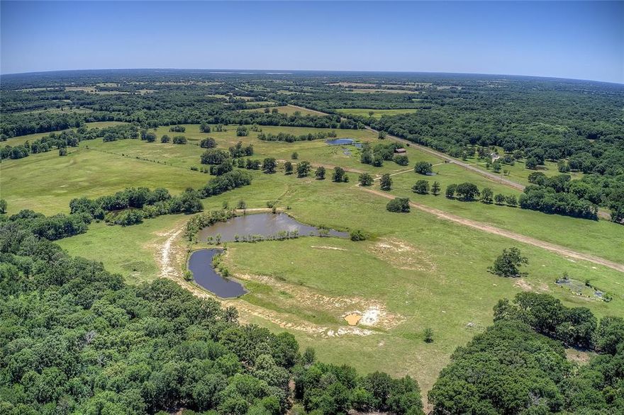 East Texas ranch offering a mixed-use of ranching and recreation combined into one great opportunity with 290 acres, more or less, located in Northern portion of Hopkins County, Texas. Offering a great combination of open pasture and mature mixed timber creates the perfect edge habitat for an abundance of wildlife. Improved and maintained grasses supply ample grazing for cattle and horses, working pens, piped fencing, hay meadow, 5 ponds, hay barn, cross fenced and set up for rotational grazing, piped roping arena, bucking shoots and spectator seating. Great road frontage, several great building sites and electric on site. Located one hour East of the Dallas-Ft Worth Metroplex, easy access to I-30. Don’t miss this great opportunity to own your very own ranch retreat with endless possibilities!