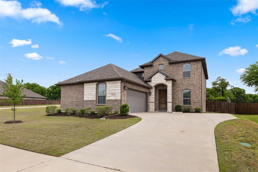 An assumable 2.875% interest rate may be available to qualified buyers, making this home an exceptional opportunity. Built in 2021 by Ashton Homes, this modern 4-bedroom, 3-bath residence sits on an oversized lot in the sought-after Oak Hills subdivision of Burleson. The open-concept design showcases luxury vinyl plank and tile flooring throughout, no carpet, and a spacious family room anchored by a cozy fireplace that flows into a chef’s kitchen with granite countertops, stainless steel appliances, a large pantry, and an inviting island for gatherings.  Downstairs includes a private guest room, a dedicated office, and the primary suite with dual sinks, a walk in shower, and a spacious closet. Upstairs opens to a second living area or flex space, along with two additional bedrooms and a full bath, giving you options for how you want to use the space. The side entry garage keeps the front looking clean, and the covered patio out back offers a comfortable spot to relax or spend time with friends and family. Located in Oak Hills and zoned to Joshua Independent School District. You’re also within about 10 to 15 minutes of Burleson Commons, Gateway Station, and Old Town Burleson for shopping, dining, and everyday needs, with quick access to I 35W for an easy drive into Fort Worth and surrounding areas.