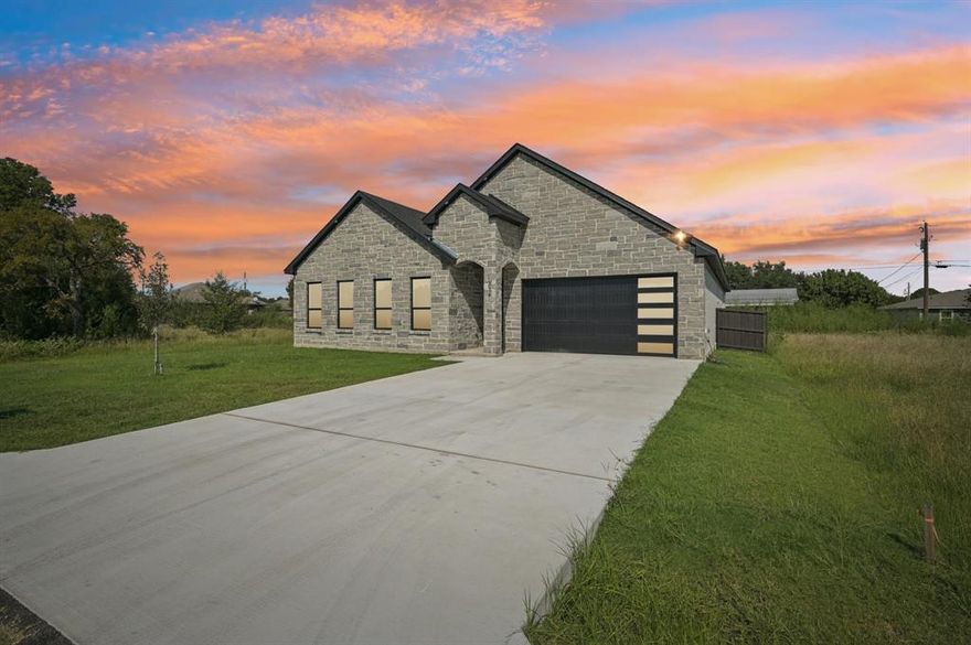 Step Into Style, Your Dream Home Is Calling You Home

From the moment you arrive, this brand new custom built beauty does more than impress, it starts a conversation. With 4 generously sized bedrooms and 3 full bathrooms, this home blends modern elegance with everyday function in a way that says you belong here.

Wrapped in eye catching Lewder stone and framed by a bold iron front door, this home welcomes you into a bright, open space that feels like it was made just for you. Inside, you will find clean lines, upscale finishes, and thoughtful touches throughout, including 8 foot interior doors, designer lighting, and luxury plank flooring from wall to wall with absolutely no carpet anywhere.

The kitchen is a true centerpiece, offering quartz countertops, a stunning waterfall island, custom 40 inch cabinets with detailed mullions, a spacious walk in pantry, and lighting that sets the perfect tone, whether you are hosting guests or enjoying a quiet evening at home.

Every bathroom offers a spa like experience with large walk in showers and modern finishes. The primary suite is your personal retreat, featuring dual vanities, a six foot custom shower, and a walk in closet that is ready to be filled.

The smart layout includes a split bedroom design for added privacy, and a well equipped laundry room with its own utility sink to handle all of life's messier moments with ease.

Step outside to a large covered patio designed for relaxing and entertaining. Thoughtful exterior lighting and ceiling fans extend the home's charm outdoors, creating a space that is both welcoming and comfortable.

With a two car garage and premium details throughout, this home delivers modern style, quality craftsmanship, and true move in readiness. Every corner reflects a commitment to comfort, style, and function. All that's missing is you.