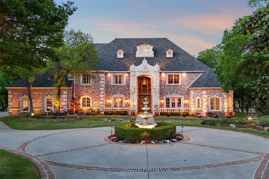 An extraordinary expression of luxury & exclusivity, this one-of-a-kind estate is tucked away on a private 1.6 acre wooded cul-de-sac lot in the prestigious gated community of Point Noble, along the coveted north shores of Lake Grapevine. Offering an unparalleled 523ft of pristine lake frontage w-unobstructed views of protected core land, this remarkable residence delivers ultimate privacy, breathtaking natural beauty & direct access to the water via a private road & boat launch. Spanning three levels, this impressive estate features 6 bedrooms, 3 expansive living areas, 2 elegant wet bars, a wine cellar, 3 fireplaces + a 3.5-car garage, all seamlessly connected by a private elevator which leads up to a guest apartment, perfect for multigenerational living. Every detail has been curated for both grand-scale entertaining & refined everyday living, from the resort-style outdoor oasis featuring a stacked stone pool, infinity-edge spa & multiple cascading waterfalls, to the fully equipped outdoor kitchen w-premium SS grill, flat top, Green Egg, sink + fridge. The grounds rival a private park, complete w-a tranquil koi pond, a winding lazy river, granite walking paths, landscape lights, a fire pit + a picnic area overlooking a peaceful cove, frequented by deer & blue heron. Inside, sophistication meets innovation w-a stunning 200-gallon in-wall saltwater aquarium, a tiered theater room w-140-inch screen & a smart home integration, including whole-house audio, extensive Z-Wave lighting, security cameras + advanced water monitoring systems. Built to the highest standards, the home boasts a reinforced engineered foundation wi-72 belled piers, 2x6 foam-insulated construction, Pella wood windows & doors + a 2024 roof & gutters. Comfort and efficiency are elevated w-4 new HVAC systems, dual tankless water heaters w- recirculation & multi-zone smart irrigation. Private patios extend from nearly every major room, creating a seamless indoor-outdoor lifestyle immersed in nature.