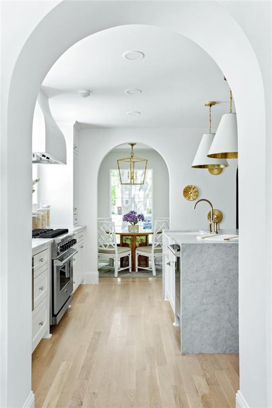 Experience this timeless Highland Park home resembling a castle, built by R + D Residential with interior design by Jessica Koltun Home that honors classic clean lines with a contemporary flair. Enter through the stunning foyer with dramatic arches that flows seamlessly into the family room, and kitchen boasting light from every direction. Amenities include a chef's kitchen with Viking appliance package, custom acrylic wine wall, venetian plaster fireplace and spiral staircase, and dry bar with brass shelving. A full guest suite or optional sunroom with pool bath on the first floor overlooks the sparkling pool with a fully turfed yard. The primary bedroom is outfitted with a spa-like bath dripping in marble, a freestanding tub, double walk-in closets, and a private balcony overlooking the pool. This home was built for those aspiring for an architectural masterpiece that combines both live-able comfort and sophisticated design in a well-appointed location.