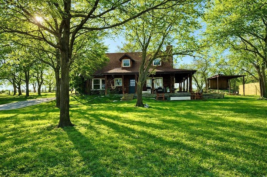 Drive through the private gate into your luxury oasis of comfort, peacefulness and timeless design. Beautifully renovated, 3bdrm 2.5 bathrms, unique log home boasts high end attributes. Rustic character meets modern style. From the moment you arrive, you’ll be drawn to the peaceful atmosphere, expansive porches; perfect for morning coffee, relaxing evenings, and entertaining guests. You have plenty of room to lounge & enjoy the tranquil outdoor setting. Inside, the shiplap wood walls along with stunning exposed logs create a cozy, inviting atmosphere throughout. The spacious living area is anchored by a gorgeous stone fireplace and flows effortlessly into the bright, open kitchen featuring crisp white cabinetry, abundant granite counters, breakfast bar and beverage space ideal for gathering. Wonderful dining area with double glass doors opening to a grand covered porch. Natural light pours in through the home, highlighting unique textures and custom finishes. Retreat to the serene, downstairs primary bedroom adorned with a bay window seat, providing a relaxing feel, complemented by an en-suite spa-like bathroom. A blend of farmhouse elegance and cabin warmth make every room feel cozy. Stunning tile and real wood floors throughout. This one-of-a-kind property offers the perfect combination of comfort, character, and curb appeal, ready to welcome you home. All 3 bedrooms are oversized with room for sitting areas in each. No known restrictions. No HOA. No city taxes. Bring your livestock to enjoy the 3+ac, with perfect area for arena with sandy soil in place, fully fenced, cross fenced and 3 stall shed row barn, plus equine vet and farrier live next door. Plenty of parking. Also has a quaint shop for all your projects! Nestled in Peaster ISD and just 10 minutes from downtown Weatherford.