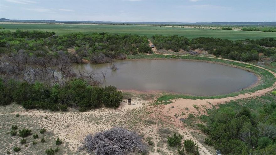 Amazing Grace Ranch.  This property is the ultimate retreat.  An improved road leads you to a well built barndominium style cabin.  There is a porch on the east side of the cabin that is great for watching wildlife in the evenings. There is an additional living space for guests in the open shop located next to the cabin with its own full bathroom.  The covered shop area also has a stainless steel sink for cleaning any game that may have been taken.  The owner has spared no expense in making this a quality hunting operation.  There are 5 blinds strategically placed across the acreage all of which will convey with the sale. Around 90 acres in cultivation that is normally planted in wheat with the remainder in pasture.  There are two tanks on the property that both have fish in them.  The deeper of the two is 25-30 feet deep.  New 5 strand barb wire fences have been put up in the past several years around the whole property.  There are two water wells on the property.  The house water is supplied by Blair water.