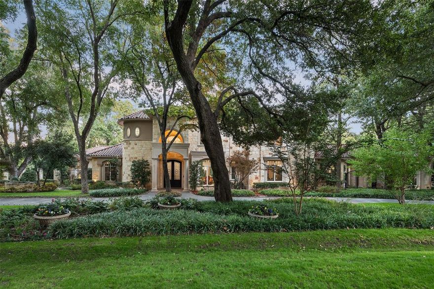 Custom-built Transitional manse perfectly situated within Preston Hollow’s Forest Lane Estates on a 1.035-acre wooded corner lot. An elegant, marble foyer with a sweeping staircase welcomes you into the grand living and dining rooms, overlooking the lushly-landscaped back yard. The downstairs primary bedroom boasts high ceilings, dual closets, double vanities, and a lovely view of the backyard oasis. A fitness studio, and the gorgeous oak study are conveniently situated just outside the primary suite.  

The airy great room holds an oversized mantle, dividing the bright living spaces. The formal dining room is accompanied by an adjacent wet bar that creates the perfect space for entertaining guests. The chef’s kitchen boasts a pink-granite island, with a breakfast bar, updated stainless-steel appliances, a walk-in-pantry, and an additional gas grill tucked away into the butler’s pantry. The kitchen blends into the beautifully appointed breakfast room; and extends even further to the family room, an en-suite bedroom, and an acoustically engineered media room. Upstairs, the mezzanine breezeway connects the three en-suite bedrooms, all with walk-in closets, and a spacious game room and half bath.  

The beautifully-landscaped backyard includes a covered patio, and a heated pool and spa. The winding path throughout the garden leads to a supplementary outdoor seating area, surrounded by turf. Parking is in abundance with an attached 2-car garage, an auxiliary one-car garage, a porte cochère, carport, and the oversized circular driveway.