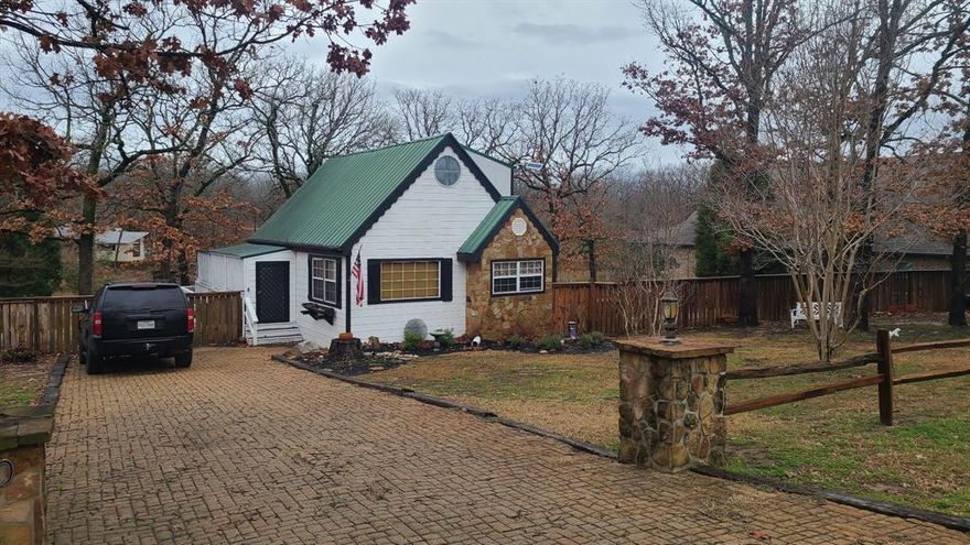 Charming 2-3 bedroom 2 bath. Fully fenced yard. New front fence. New Custom designed large shed. Updated landscape. Hardwood floors with custom inlay. Main floor bedroom and 1 bath on main level, 2 bedrooms upstairs, with bathroom on second level, one upstairs bedroom door leading out to your own private deck. Large deck off of back of home to enjoy views of springfed pond. Enjoy your own private resort feeding the turtles, deer, fishing or sit out back and enjoy the stone firepit. There is also an outdoor fireplace. Sprinkler system. There is a community pool and boat launch for Residents only. This is a perfect home for first time home buyers or a vacation property. Looking to downsize or investment property with a large private yard on 3 lots. This home has lots of character and charm!