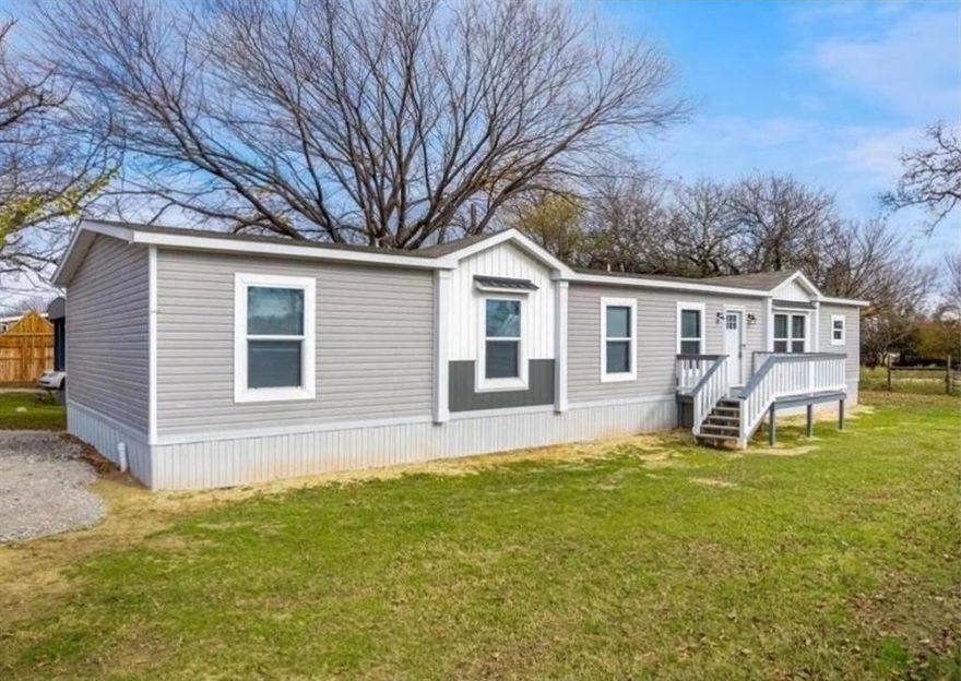 MOTIVATED SELLER!! This attractive manufactured home with farmhouse styling is on the end lot of this lakefront community with private boat access! End lot and partial fencing offer addtl privacy plus FIVE bedrooms with owners suite on opposite end. This open concept features build-ins, designer lighting, luxury vinyl plank flooring and a spacious living area open to dining and kitchen with a table serve island. Enchanting bookshelves line entrance to primary bedroom with walk in, double vanity and separate coffee bar. The combo laundry mud room features a shoe bench, hat and boot cubbies, plus 9 oversized cabinets for substantial storage. Relax on the front porch deck overlooking the grass play area. WILL NOT GO FHA, BUT FINANCING IS AVALIABLE. SELLER WILL PAY ALL CLOSING COSTS!