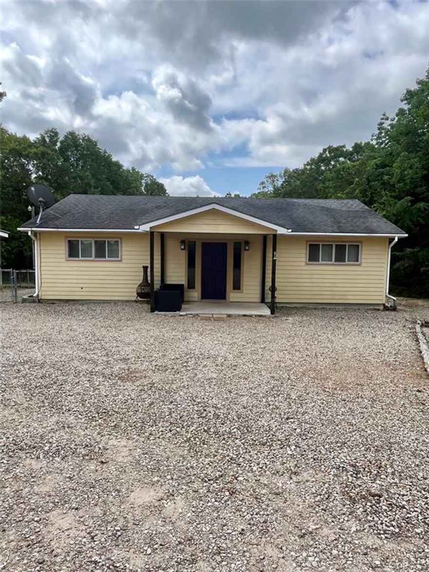 If you are looking for a quiet gem in east Texas, look no further. Located in the Cottonwood area this quaint little house on 3.936 acres is located on a Private Road. Secluded and quiet. This home has two primary bedrooms each with their own full bathroom. The living area and kitchen dining are open concept. There is also a third room behind a set of French doors that leads to the covered back porch. This room has two closets and would serve well as another bedroom, office, playroom or even gym. The backyard has a chain link fence to keep your pets enclosed. There is also room for your horses in the back of the property with wire fencing and an 8 foot gate. This home also includes a detached garage shop with two roll up doors and also a utility building which will include a freezer and a refrigerator. There is plenty of room to spread out here. This home is cozy, quaint and quiet.
