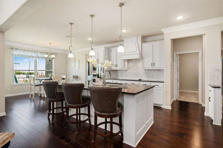 PRICED TO SELL. Due to a relocation, this is an exceptional opportunity to acquire a luxury home on a large fenced lot spanning over 1 acre at the best price per square foot in the area. Situated in the heart of Ponder, this thoughtfully designed home—just 5 years old—blends modern comfort with wide-open Texas charm. Step inside to an inviting, light-filled interior featuring simulated wood floors that flow seamlessly throughout the downstairs. The open-concept layout is crafted for everyday living and effortless entertaining. The impressive two-story family room boasts soaring ceilings and a striking gas-burning fireplace, serving as the home's dramatic focal point. This space seamlessly connects to a well-appointed kitchen, ideal for gatherings, featuring a large serving island, modern marble-like backsplash, sleek black granite countertops, and a stylish vent hood above the stove. A versatile butler’s pantry offers functionality, perfect for a wine bar or additional serving area. A private office at the front, complete with French doors, delivers an ideal work-from-home setup. The primary suite offers a sanctuary with a spacious bedroom and a spa-like bath, featuring separate vanities, a soaking tub, and a separate shower. A generous walk-in closet ensures ample storage. Secondary bedrooms provide flexibility for guests and family. Upstairs, a vast bonus room presents endless possibilities—perfect for a media room or game room. Outdoors, the backyard has been upgraded with perimeter fencing and includes a covered patio for relaxation or entertaining amidst the beauty of country living. With ample space for recreation or gardening, this property offers a rare blend of tranquility and accessibility. Conveniently located with easy access to Hwy 380, enjoy the perfect balance of rural living, just 15 minutes from city conveniences. A backyard-pool retreat with enhanced privacy rendering is available to visualize endless possibilities.