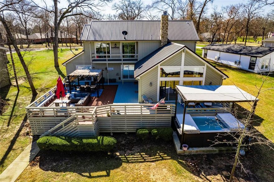 Stunning Waterfront Chalet located in a premier neighborhood!  Nestled on an oversized lot with 139 of pristine shoreline, this exceptional home offers breathtaking water views and an unparalleled lifestyle.  The beautifully designed kitchen features granite countertops and large serving bar, seamlessly opening to a spacious living area with vaulted ceilings adorned with large picture windows and a charming stone fireplace.  Step outside to an expansive deck and balcony, perfect for entertaining, or unwind in the swim spa overlooking the water.  The double boathouse ensures easy lake access making this a true waterfront retreat.