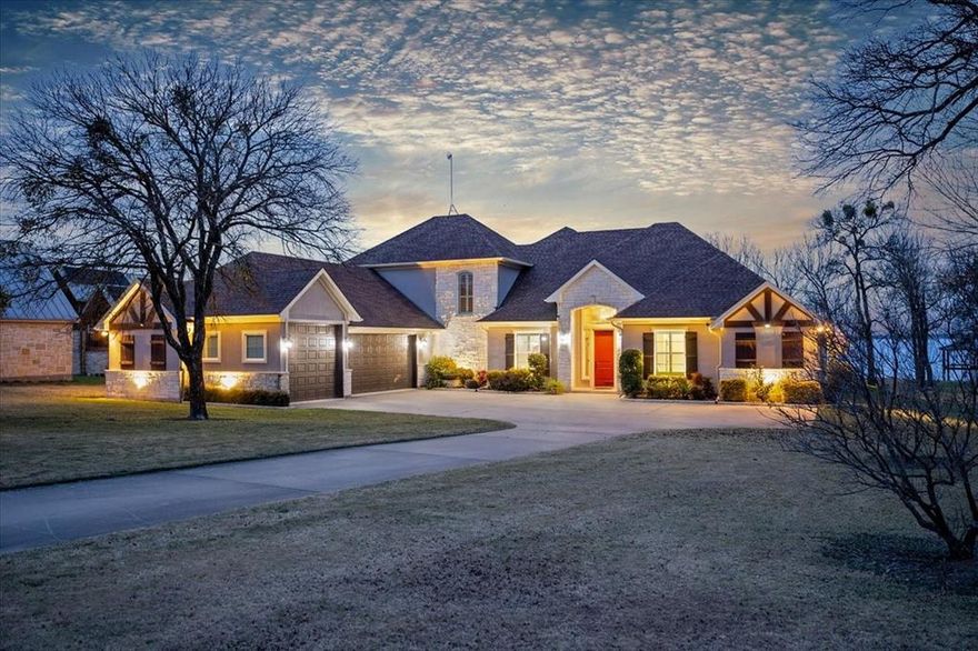 Step inside this thoughtfully designed 4-bedroom, 4-bath home where quality finishes and effortless entertaining take center stage. An open-concept layout flows seamlessly around a huge kitchen island, making this space ideal for gatherings large and small. The kitchen shines with stainless steel appliances, a nugget ice maker, and beautifully crafted knotty alder cabinets and built-ins that add warmth and character throughout. The dedicated office could easily be used as an extra sleeping space.

Porcelain tile and plush carpet balance durability with comfort, while plantation shutters bring timeless style and natural light. The primary suite feels like a retreat, featuring a barn door entry to the spa-like bath and walk in shower plus a lot of built ins. Adjacent closet has extra storage in the peninsula with another well thought out design - the closet leads directly into the large laundry room! Plus two more split bedrooms on the first floor. An upstairs bedroom with its own bath creates the perfect bunk room or guest retreat, while the main level keeps everyone connected with open living and entertaining spaces.

Outdoors is where this home truly sets itself apart. Enjoy a tiled back porch with a wood-paneled ceiling, perfect for relaxing evenings or entertaining guests. The boathouse with two boat slips and a seating area invites lake days and sunset views, creating a lifestyle—not just a home. Lawn sprinkler system supplied from lake water!
Additional highlights include fully decked storage above the garage and thoughtful details throughout that elevate everyday living.  This is a rare blend of craftsmanship, comfort, and waterfront lifestyle—ready to be enjoyed from day one.
