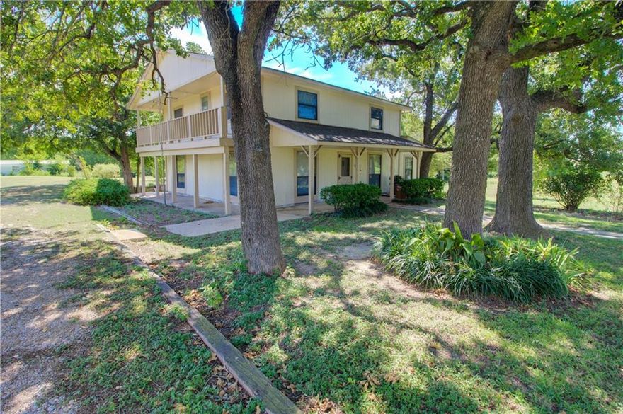 About half a mile off Hwy 7 and only ten minutes from downtown Marlin, you will find this 2500+ sq ft, 2 story home surrounded by a variety of mature trees and beautiful natural landscaping, sitting on 3.5 acres on the edge of a shared tank. Enter thru the front door into the spacious living area and open concept kitchen, with the dining area thru the double doors. Also on the main floor is the original primary suite, with tub/shower combo and space for washer/dryer hookups. Continue upstairs, and you will find two doors--one leading straight into a spare bedroom, and the other leading into what could be a large living/play area with an additional bedroom and full bathroom off it, or this space could be used as a massive primary suite with an ensuite bathroom and attached nursery/office space—your choice! Upstairs, make sure to step out onto the deck to enjoy the view of the ducks and geese in the tank. Take in the great outdoors from the porch, which wraps around 3 sides of the home. This property also features covered boat storage, along with an open detached 3 car garage/storage shed. This beautiful home could use a little TLC to get back to its prime, but is being sold AS-IS.