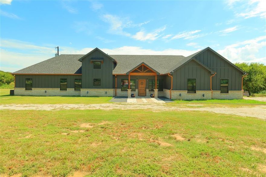 Nestled on 4.59 acres of Texas countryside, this stunning 2022-built home blends modern comfort with rustic charm. Boasting 4 bedrooms and 3.5 baths, it offers an open floor plan with warm wood accents, a chef’s kitchen, and a cozy fireplace. Step outside to your own slice of country paradise—gather fresh eggs from the chickens (yours to keep), soak in the hot tub under a starry sky, or tackle projects in the shop equipped with electricity. With room to roam and endless opportunities to make it your own, this property is the perfect mix of peaceful living and endless adventure!