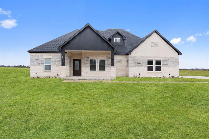 Set on 4.99 acres in Greenville ISD, this bright and beautifully maintained 2024 brick home offers modern comfort with room to breathe. The 4-bedroom, 2-bath layout features an open, light-filled interior with stainless steel appliances, granite countertops, and decorative lighting throughout. Outside, enjoy wide-open space and a huge storage shed—perfect for equipment, hobbies, or extra storage. Clean, modern, and move-in ready, this property delivers country space with new-construction confidence.